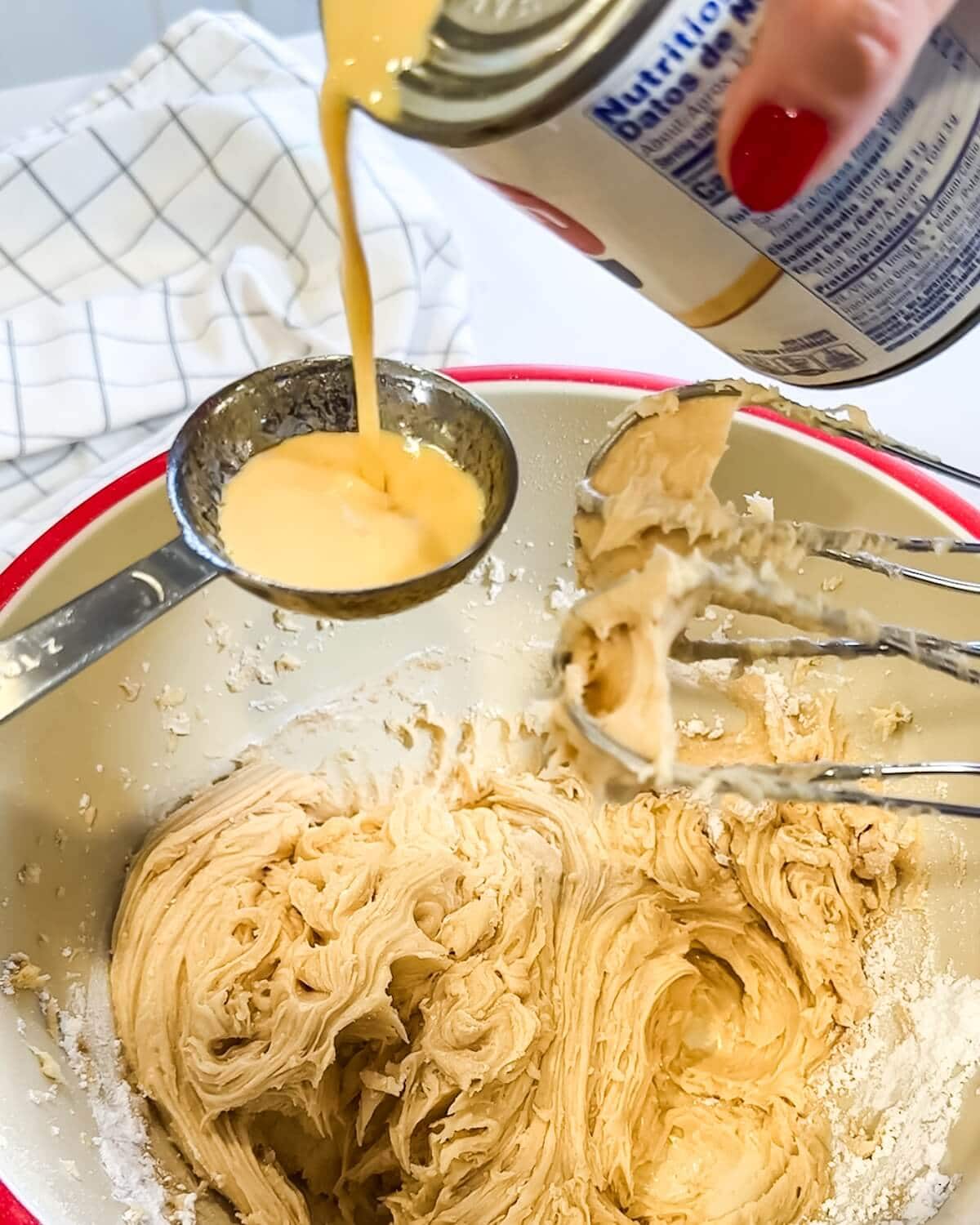 Adding a little evaporated milk to browned butter frosting to thin it.
