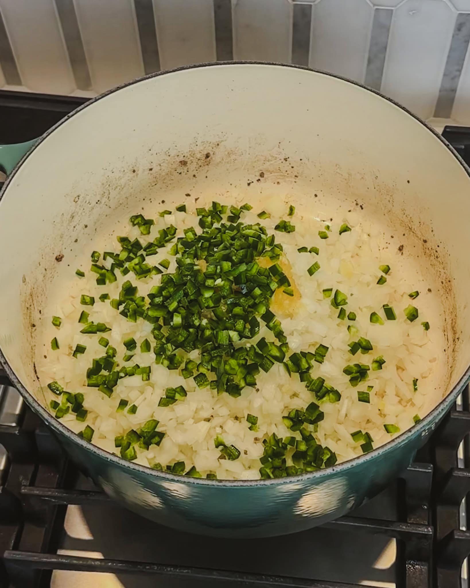 Cooking onions, jalapeno, and garlic in a large pot for chili.