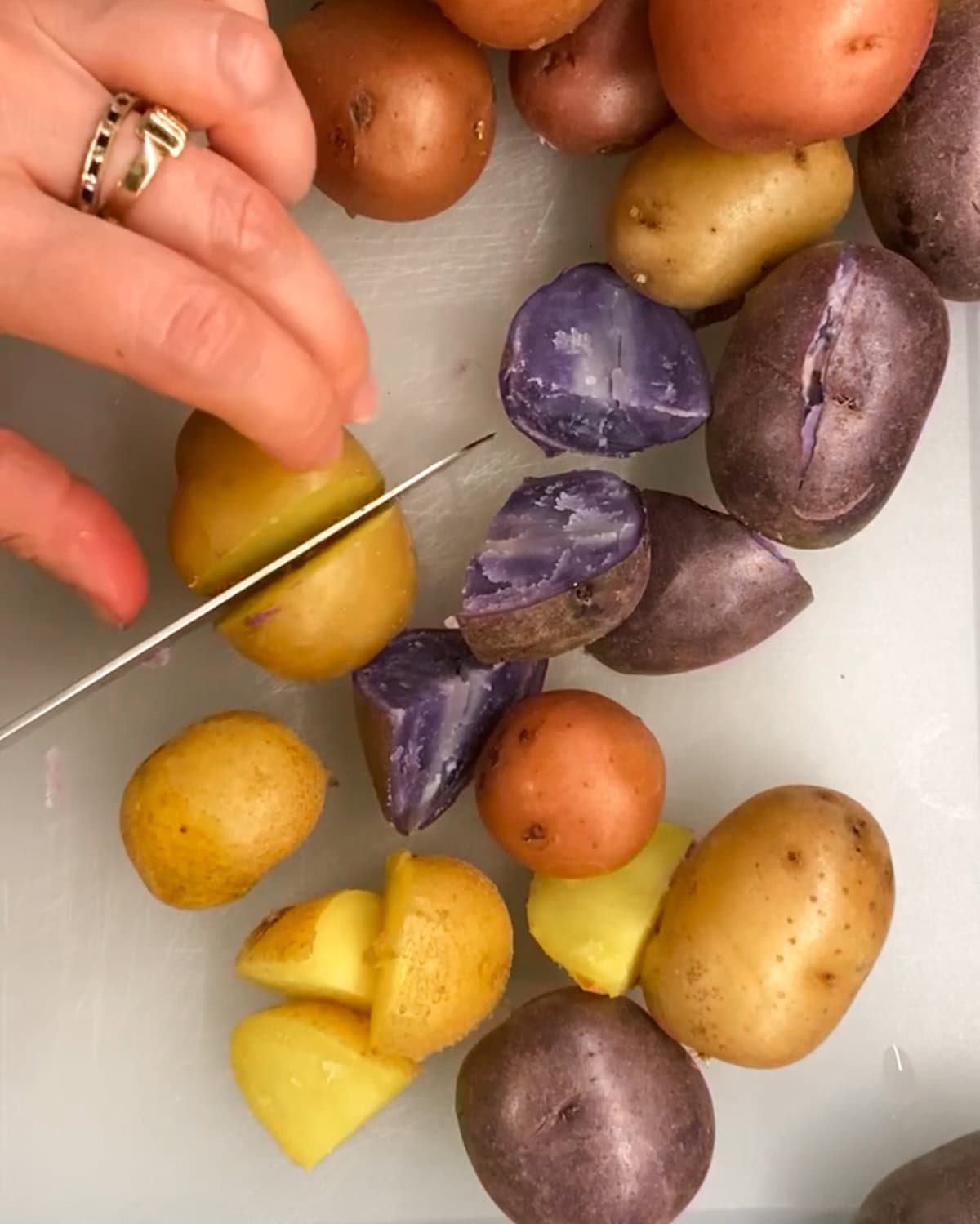 cutting cooked potatoes on a cutting board
