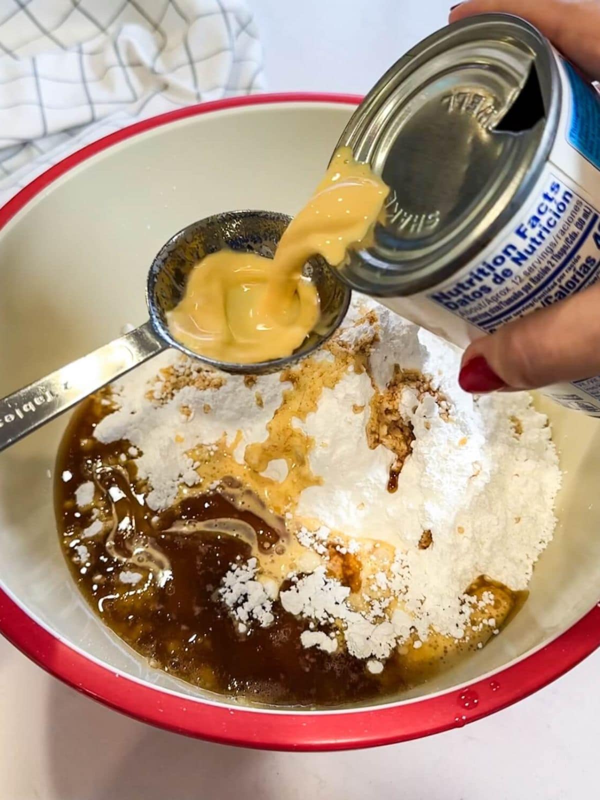 bowl of confectioners sugar with brown butter and evaporated milk for frosting.