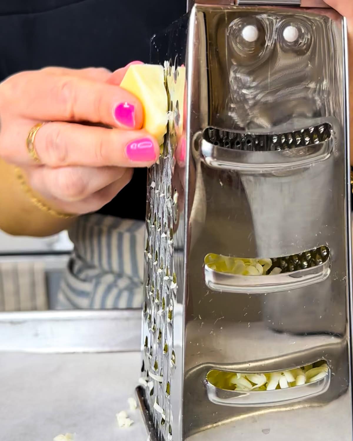 Grating cold butter on a box grater. 