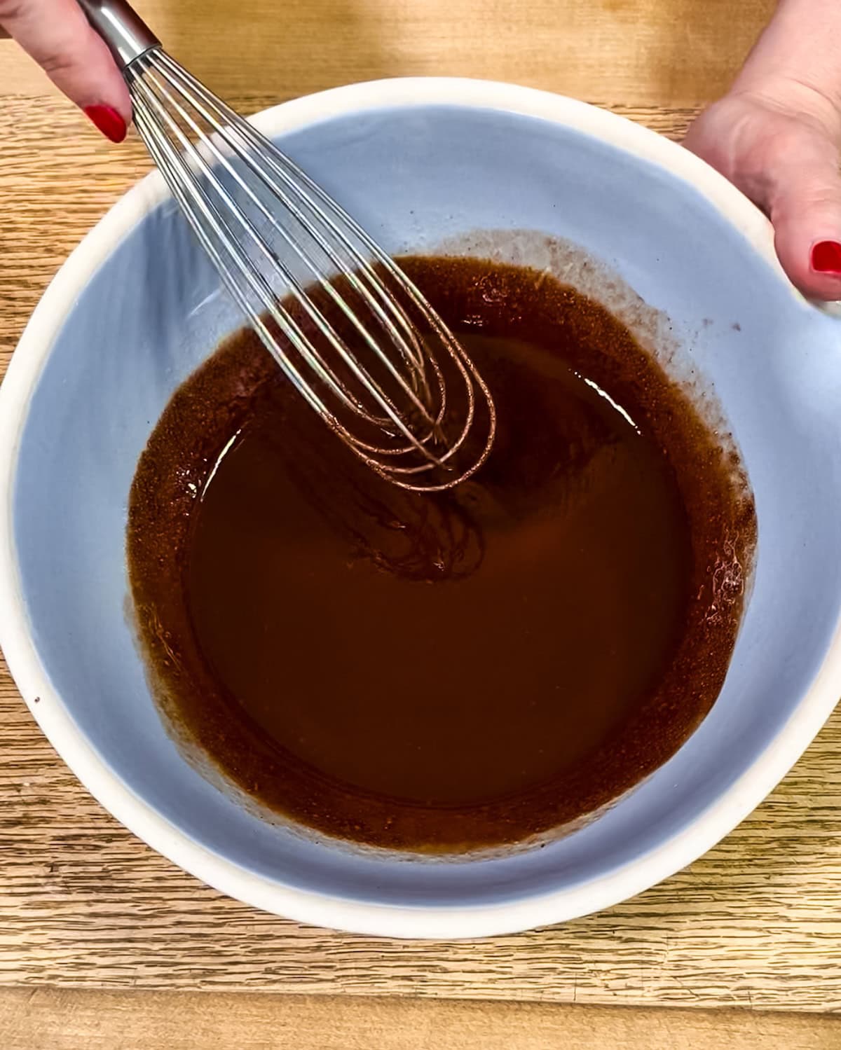 Smooth chocolate mixture in a bowl after eggs have been added.