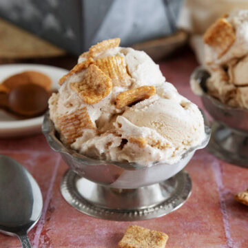Scoops of cinnamon toast crunch ice cream in a metal dessert bowl.