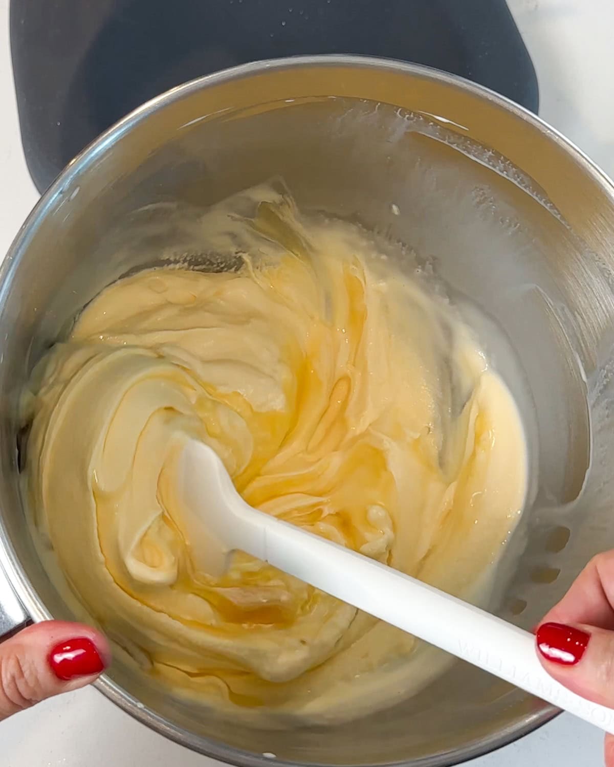 Stirring lemon curd into softened ice cream.