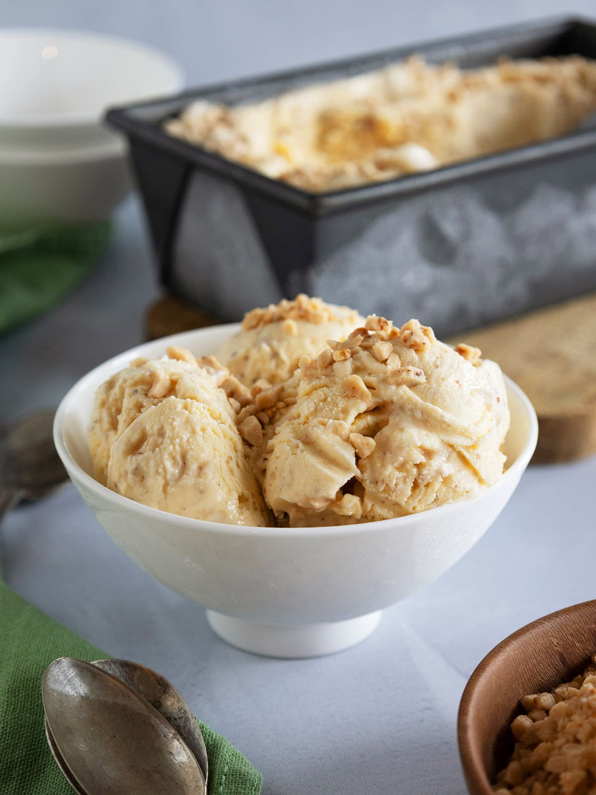 Several scoops of browned butter ice cream in a small white bowl.