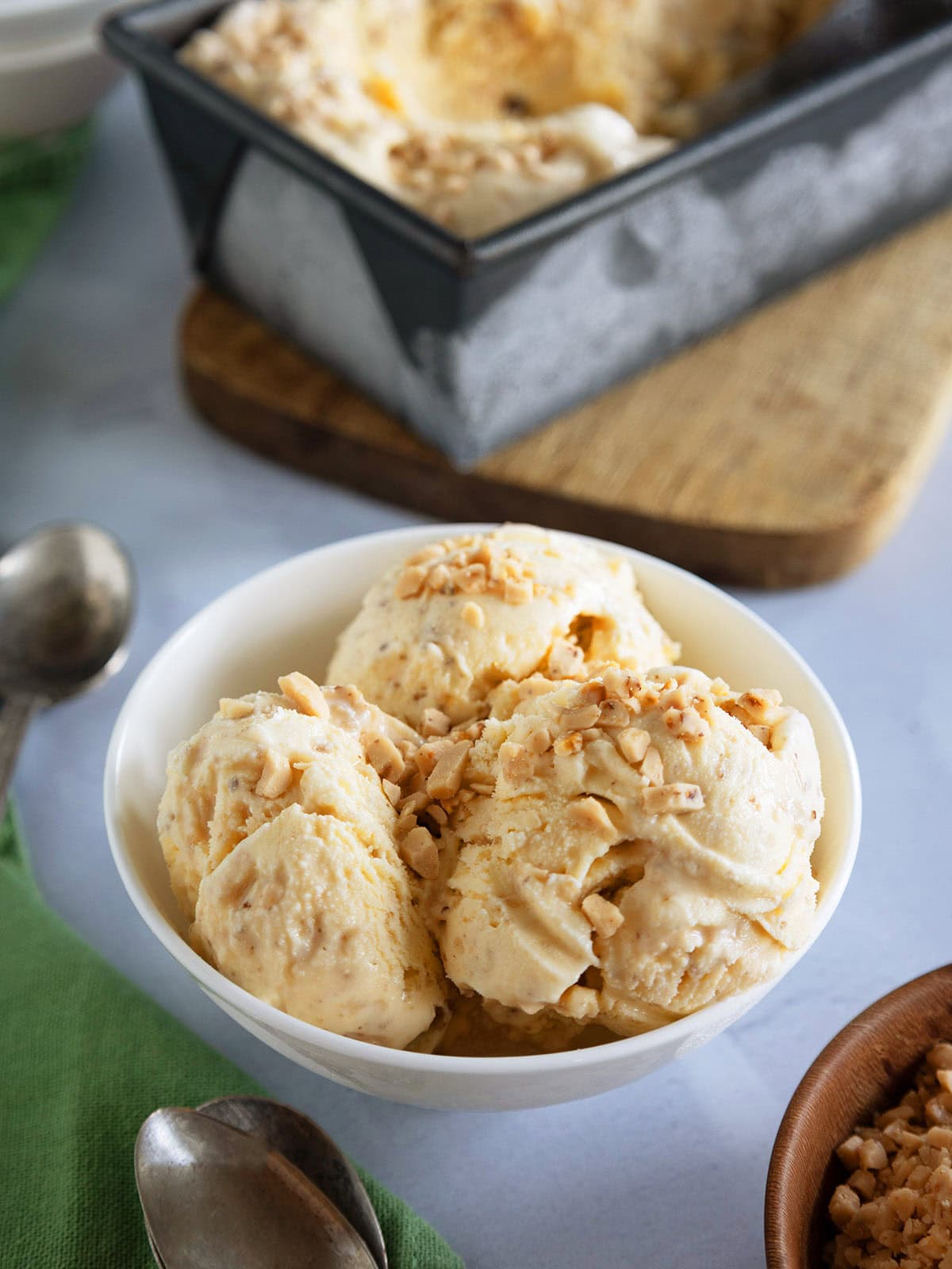 Several scoops of browned butter ice cream in a small white bowl.