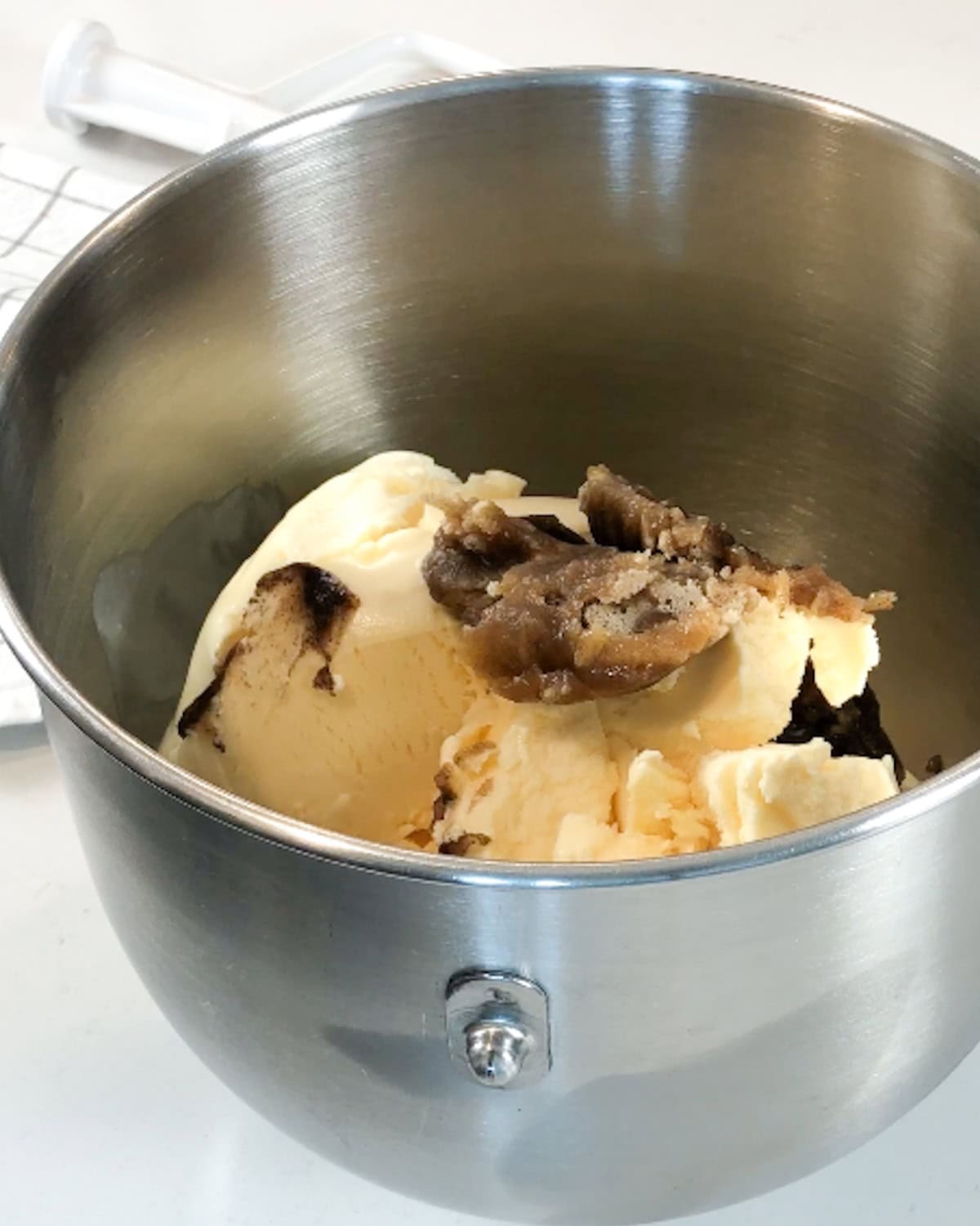Browned butter and vanilla ice cream in a mixer bowl.
