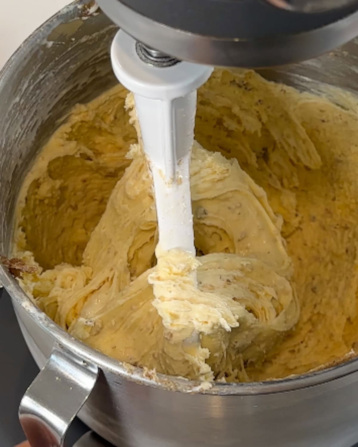 Browned butter ice cream being mixed together in a mixing bowl.