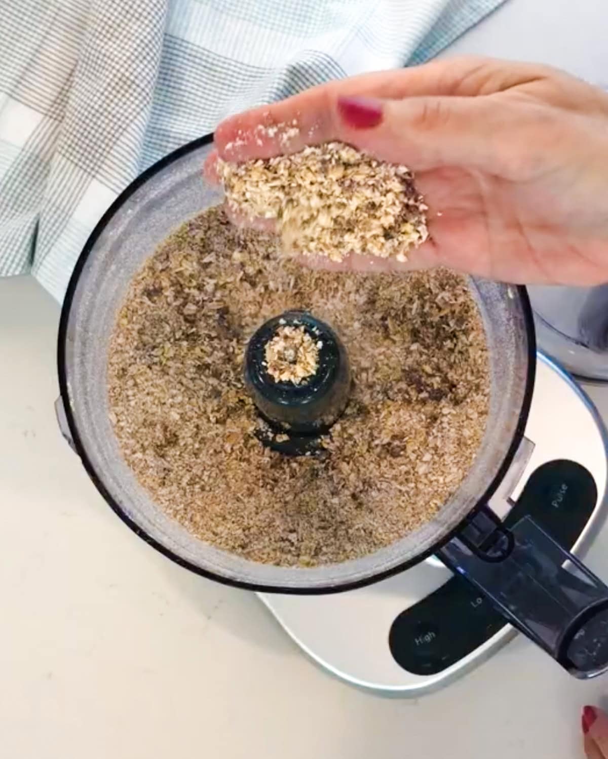 Blended oatmeal and raisins in food processor for oatmeal iced cookies