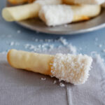 Close up of a coconut pirouette cookie.