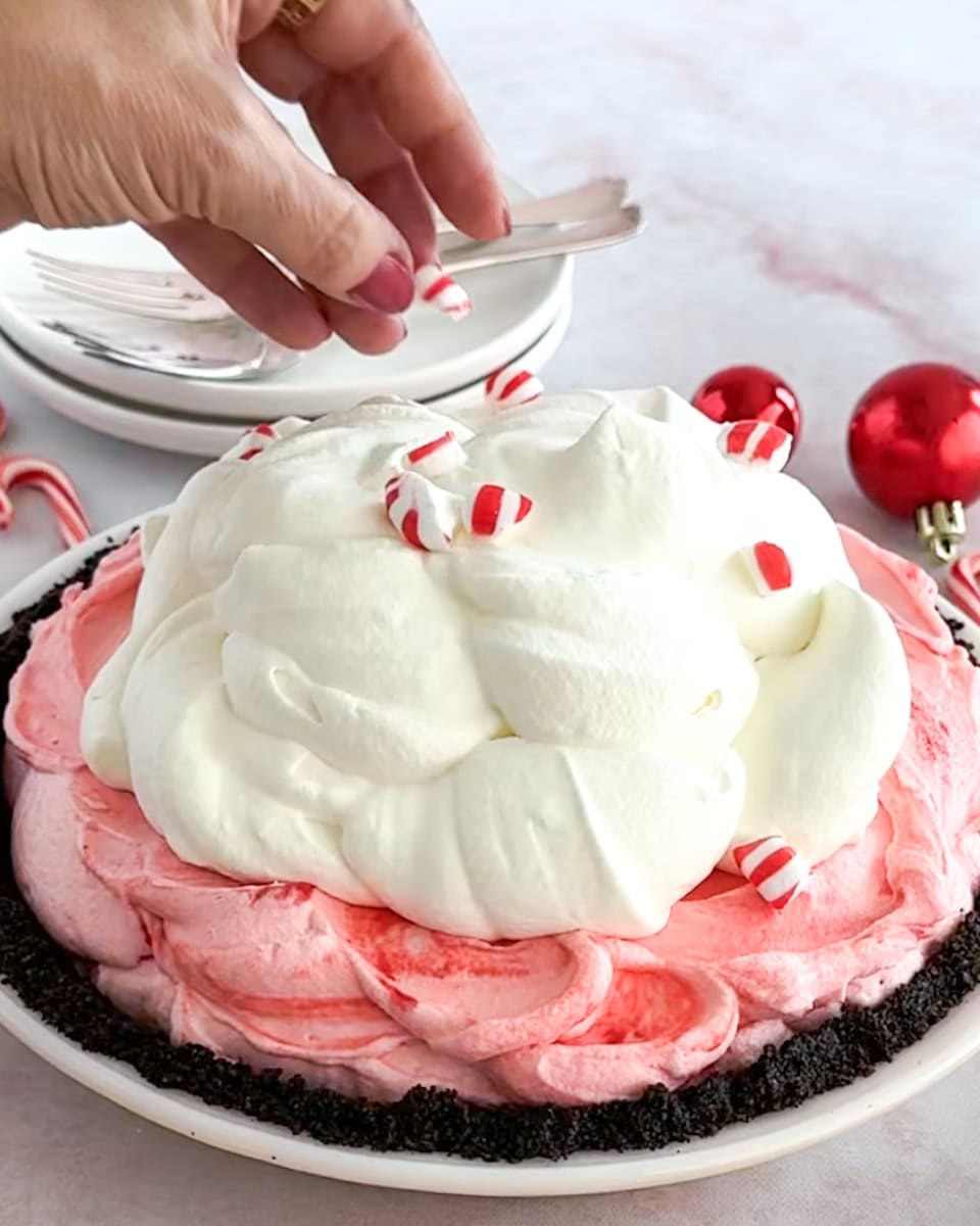 Topping a peppermint pie with crushed mints.